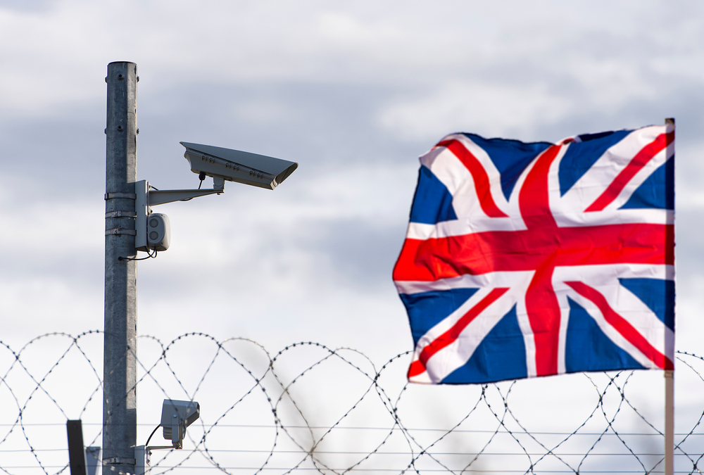 Flag,Of,The,United,Kingdom,With,Surveillance,Camera,And,Barbed UK MIgrants