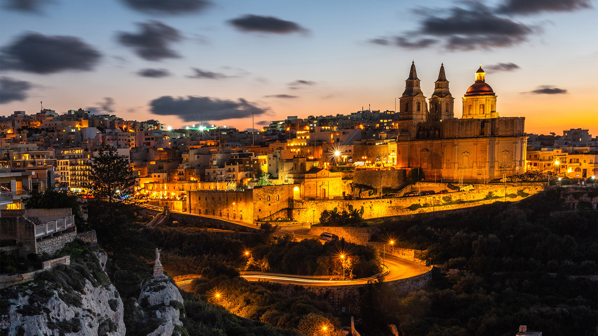 Il-Mellieha, Malta - illuminated Mellieha town at blue hour with Paris Church on hill top.