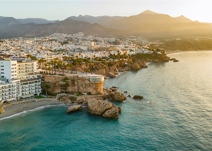 shutterstock_2476208641 Aerial view of the famous mirador view point Balcon de Europa in Nerja resort town on Costa del Sol Mediterranean sea coast at sunrise in Andalusia, Spain
