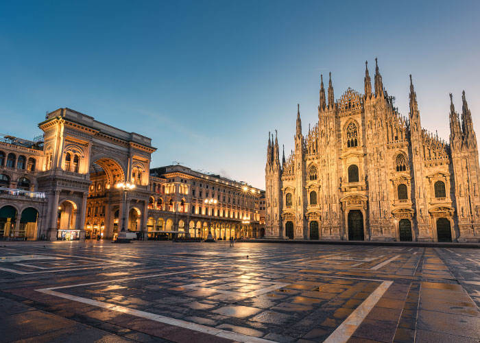 Duomo di Milano with Galleria Vittorio Emanuele II illuminated at dawn in Piazza del Duomo, Milan, Italy